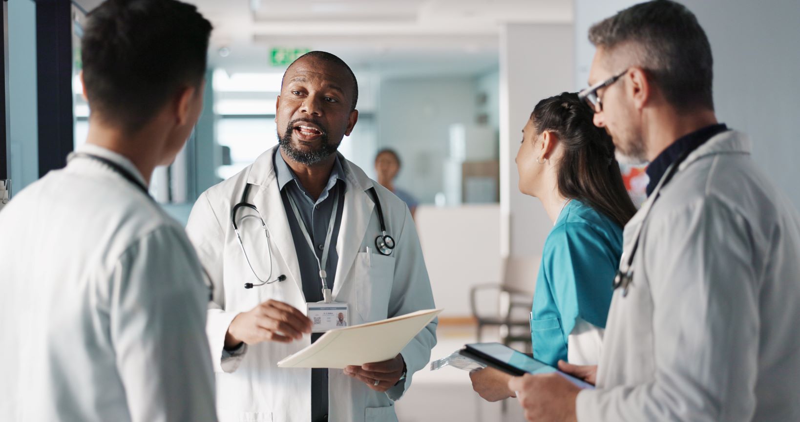 Healthcare leadership communicating with team members.