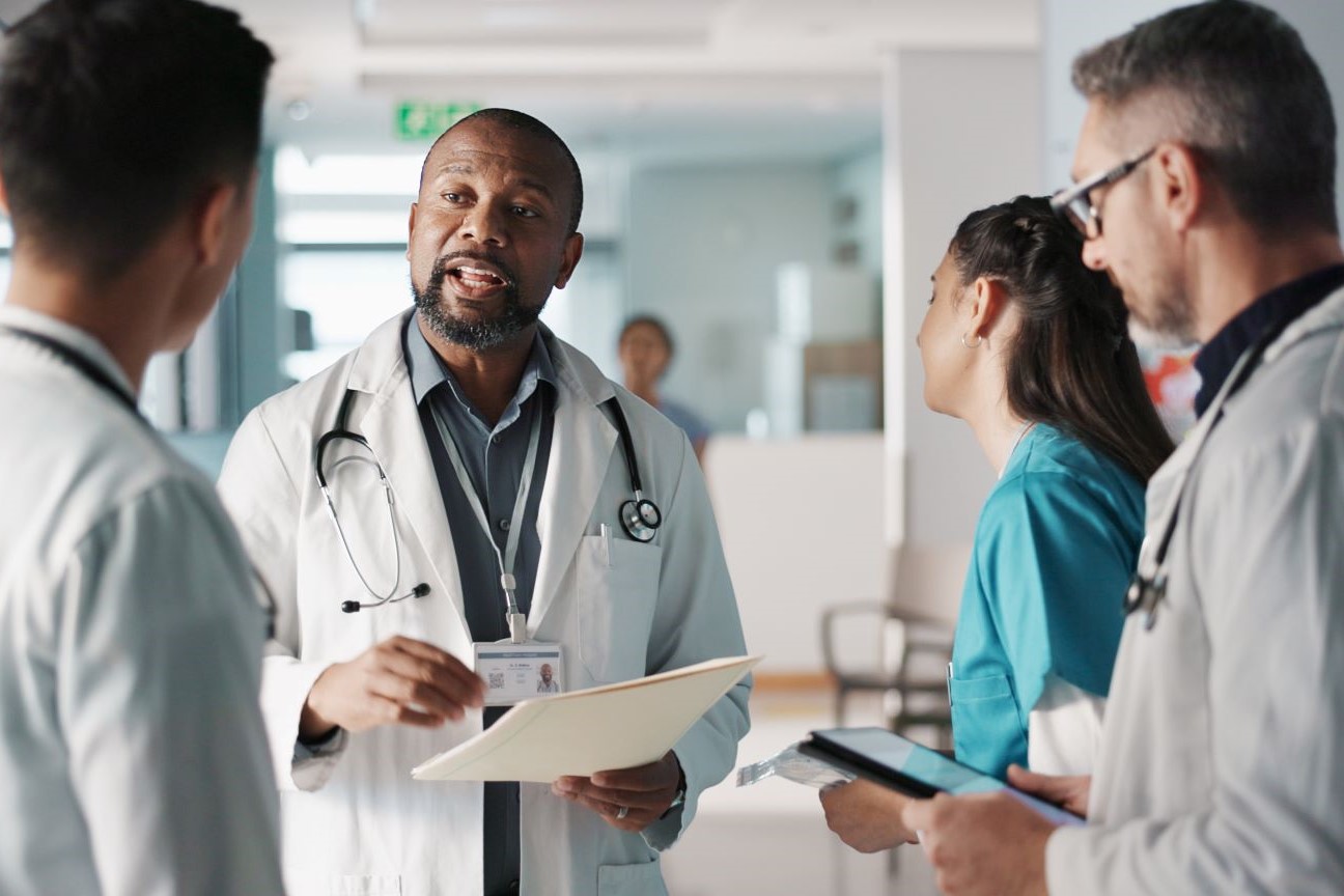 Healthcare leadership communicating with team members.