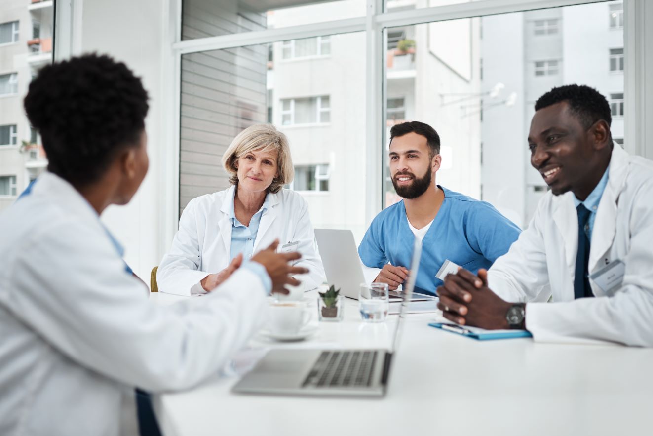 Doctor and team meeting in boardroom for medical workshop.
