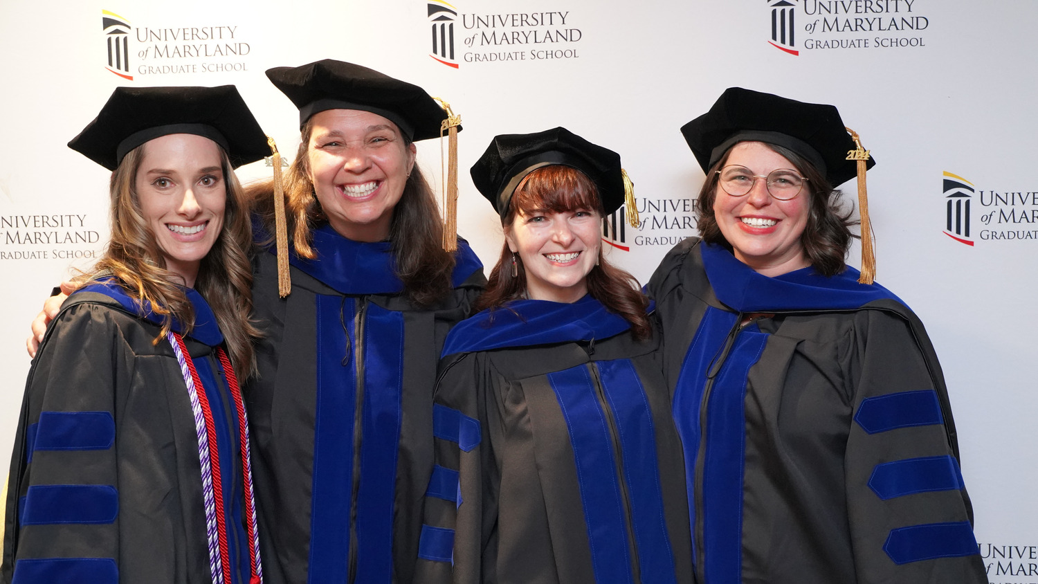 Four women in doctoral regalia